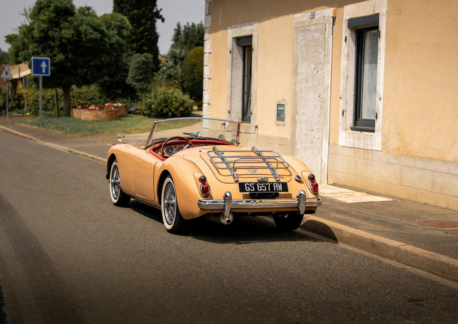 A classic convertible car is parked on the road.